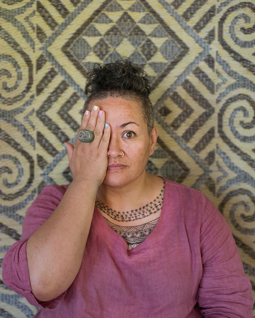Portrait of a Polynesian woman with one eye covered by her hand