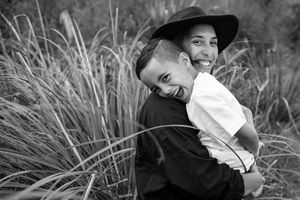 Portrait of a mother and son laughing, flax in the background