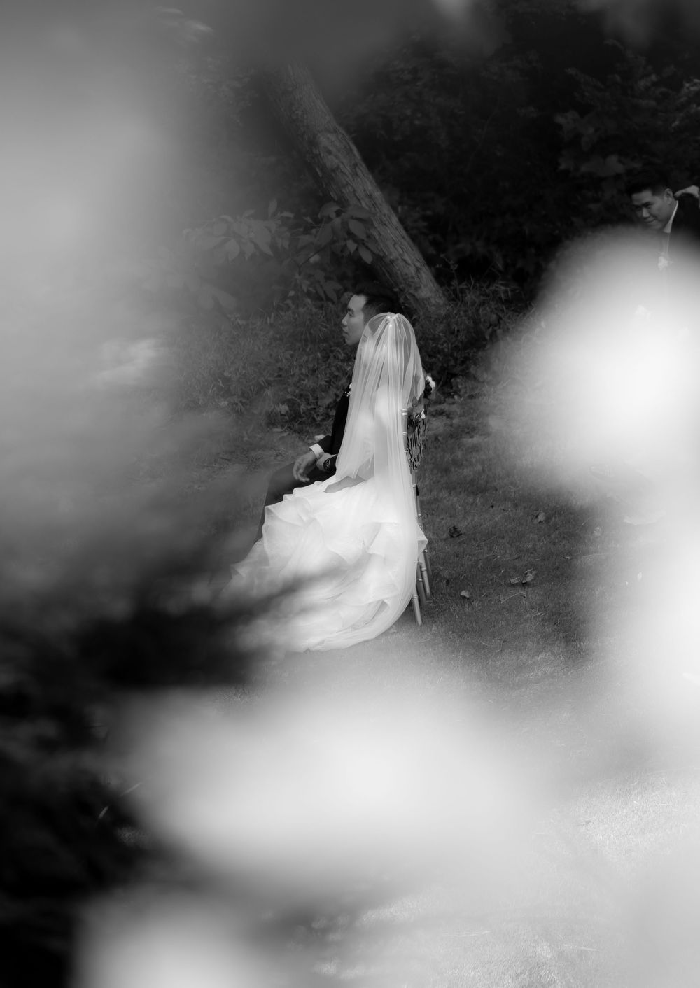 Artistic black and white photograph showing ethereal movement of a wedding dress.
