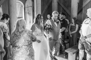Black and white collage of wedding party preparation moments showing candid group interactions in a venue hallway.