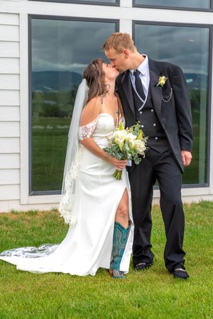A romantic wedding couple sharing sweet kisses in a sequence of progressive photos on grass near a white building.