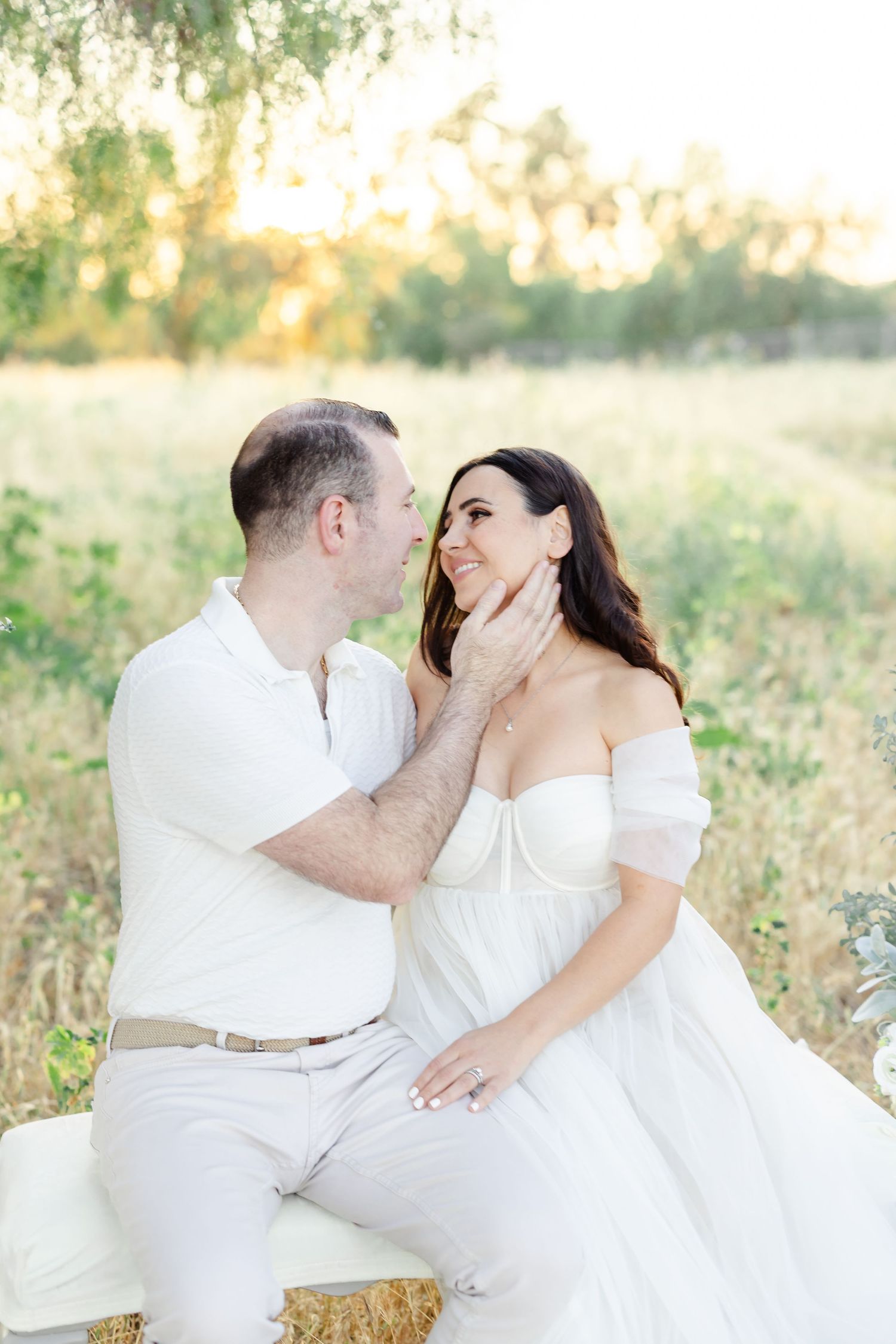 Romantic beach photoshoot features couple sharing intimate moments at golden hour.