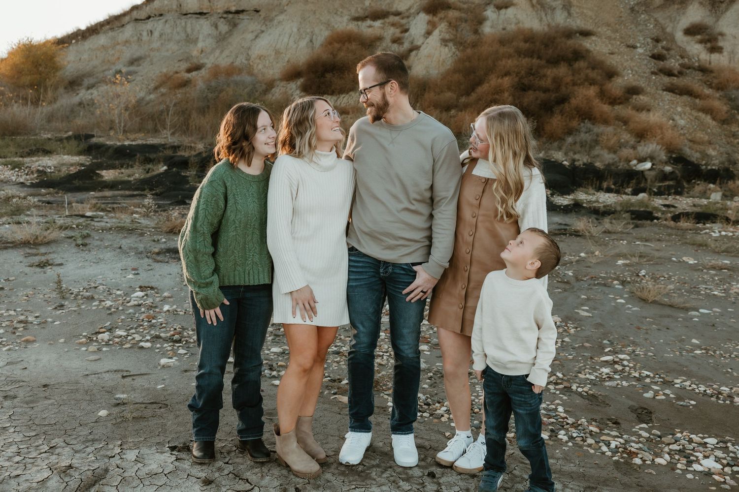 Family smiling at each other during golden hour near a lake in Garrison North Dakota family photography session