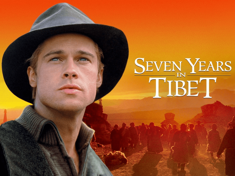 Seven Years in Tibet movie poster with an orange sunset over mountain landscapes.