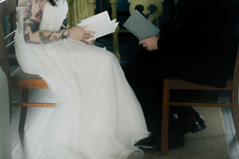 Wedding ceremony preparations in a softly lit interior space.