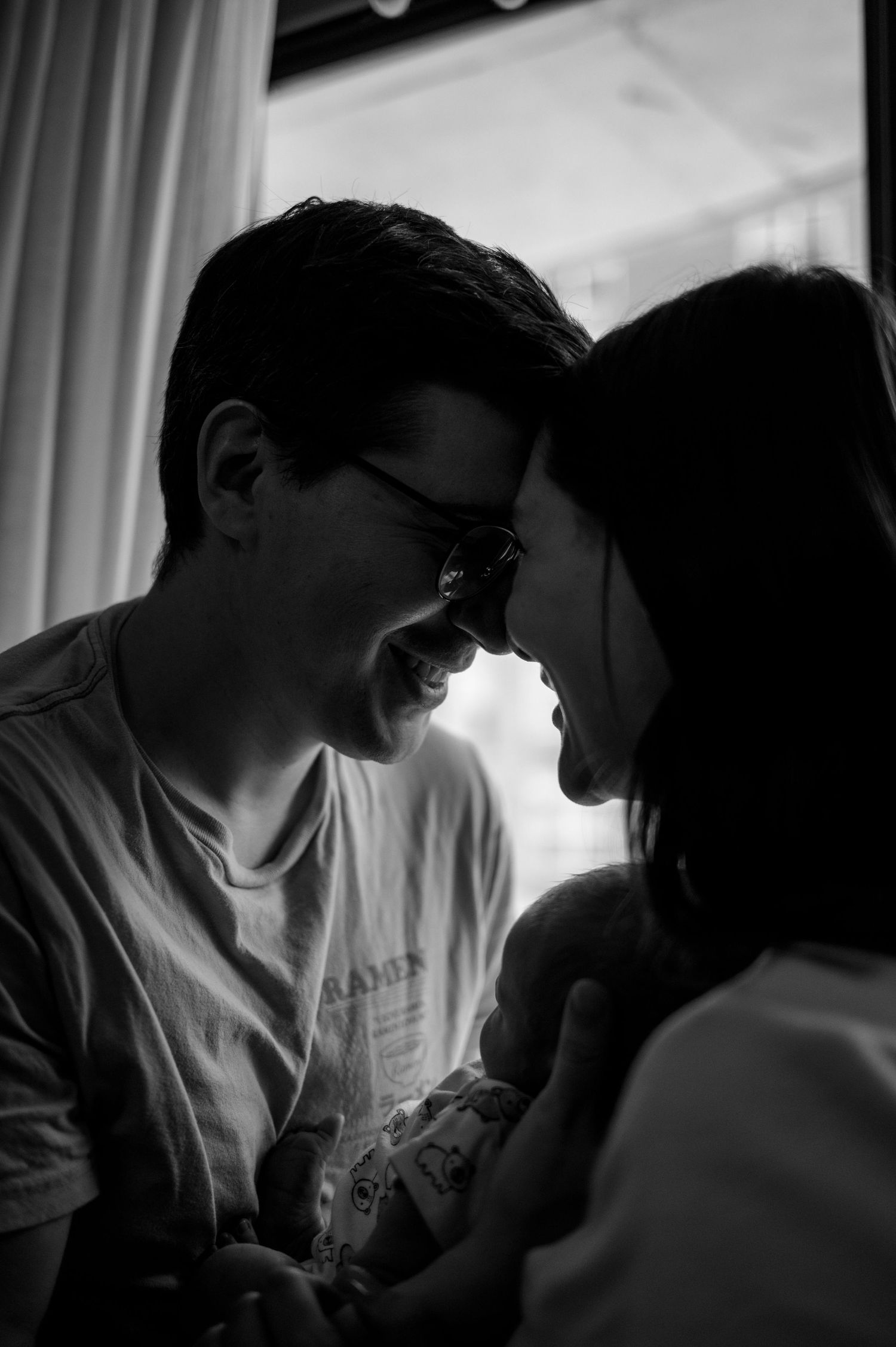 Intimate black and white portrait of a couple sharing a tender moment together.
