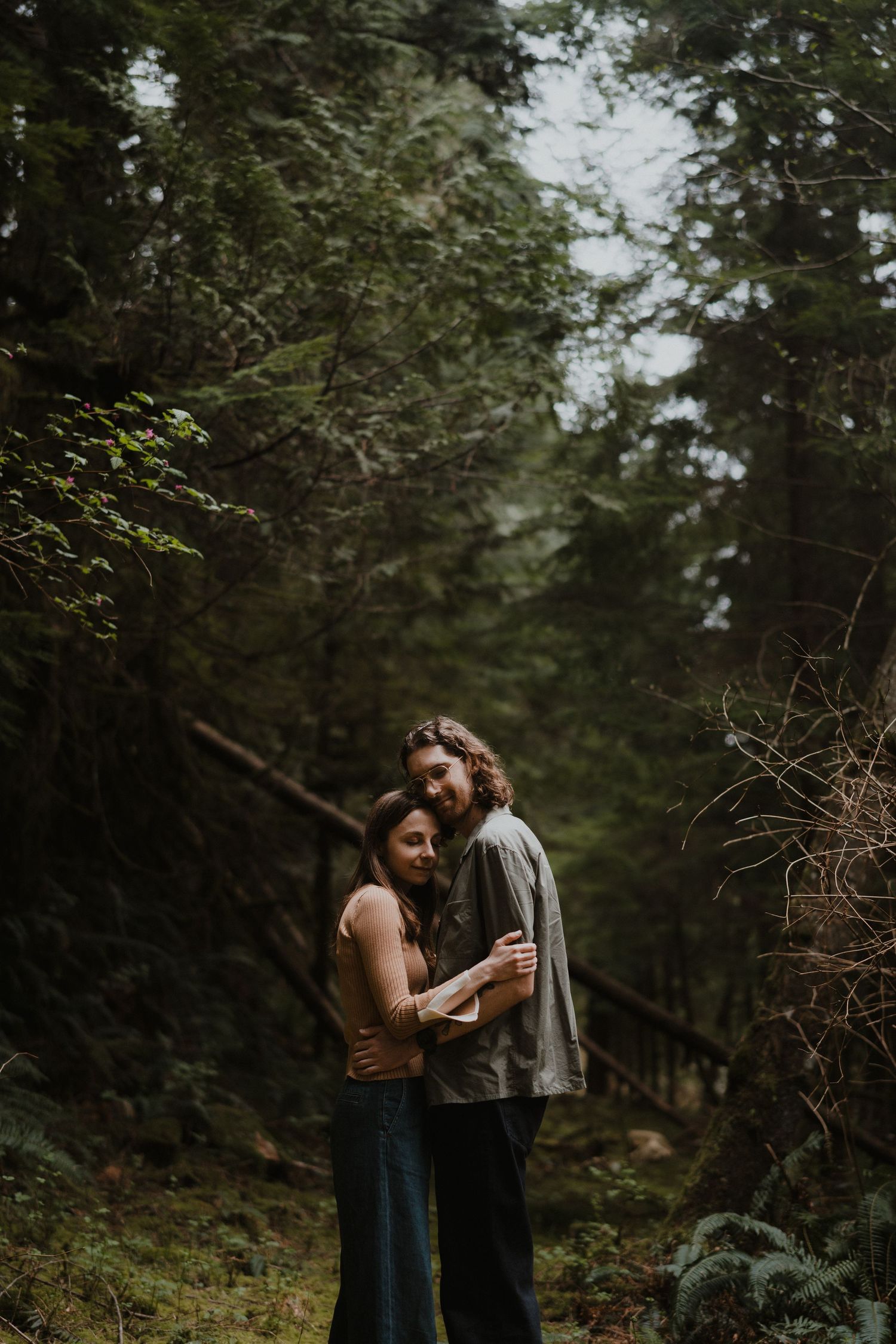 A romantic forest photoshoot with soft natural lighting filtering through the trees.