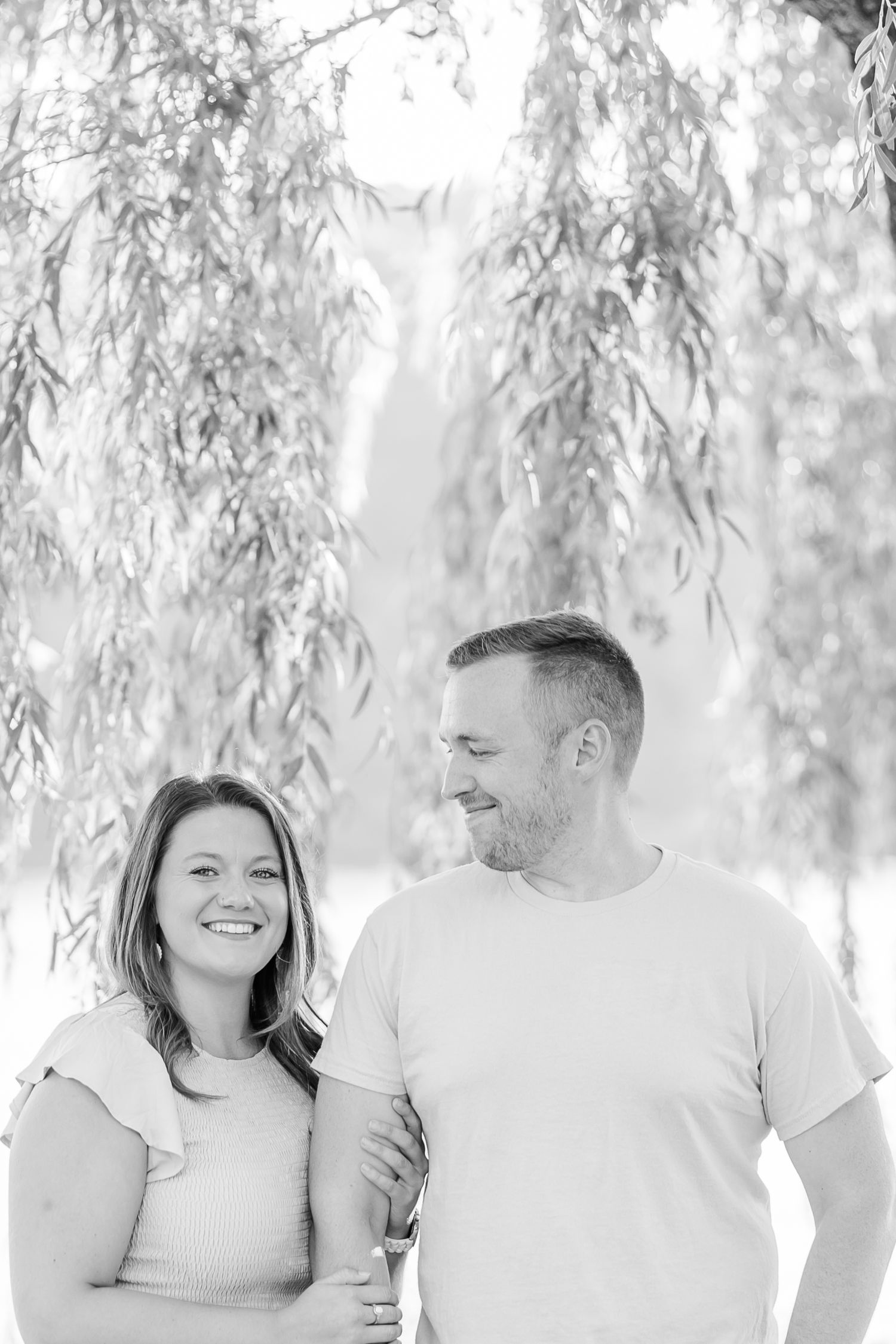 Natural light portrait session under the cascading branches of a willow tree.