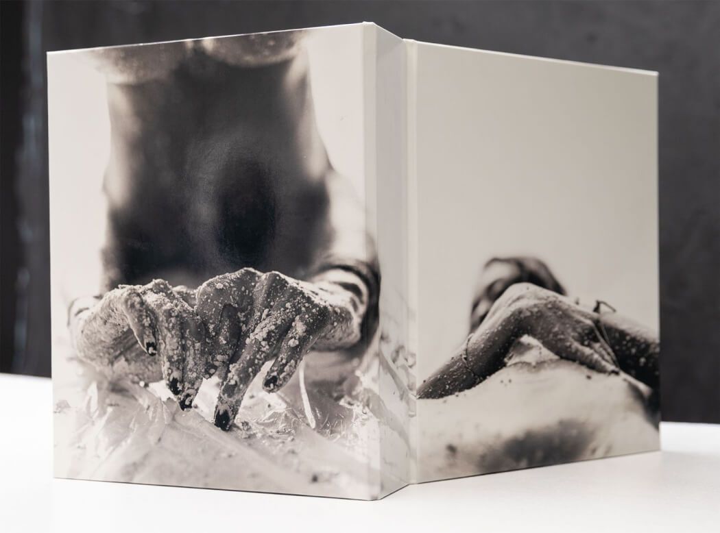Black and white photo book spread showing wildlife imagery.