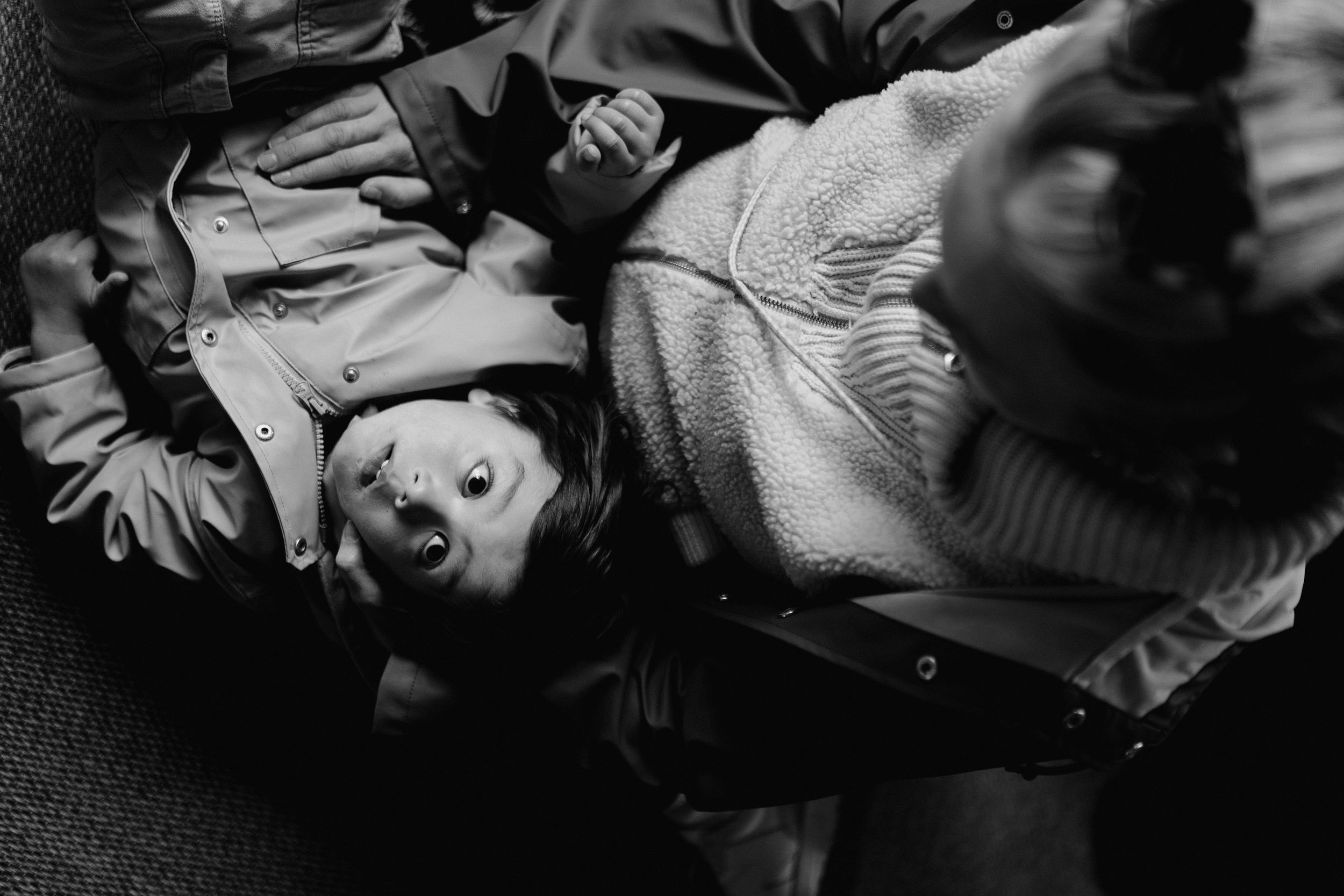 Pregnant mother with her son lying on her belly looking up into the sky