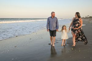 Family beach photoshoot session walking in the water sunset holding hands candid fun moment Melbourne Cocoa Vero Florida Brevard County