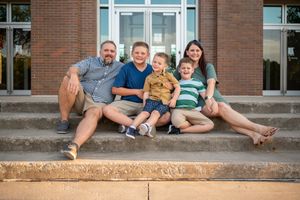 Family photoshoot session three children sitting stairs city candid smiling  sunset trees Palm Bay Cocoa Beach Vero Florida Brevard County