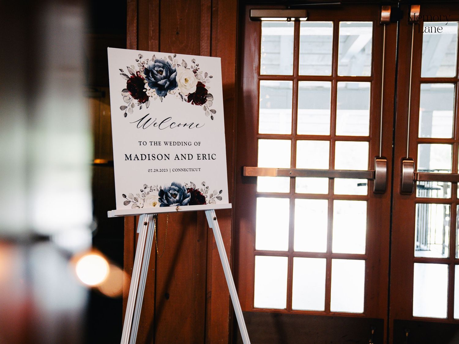 Interior view of rustic venue windows with wedding signage.