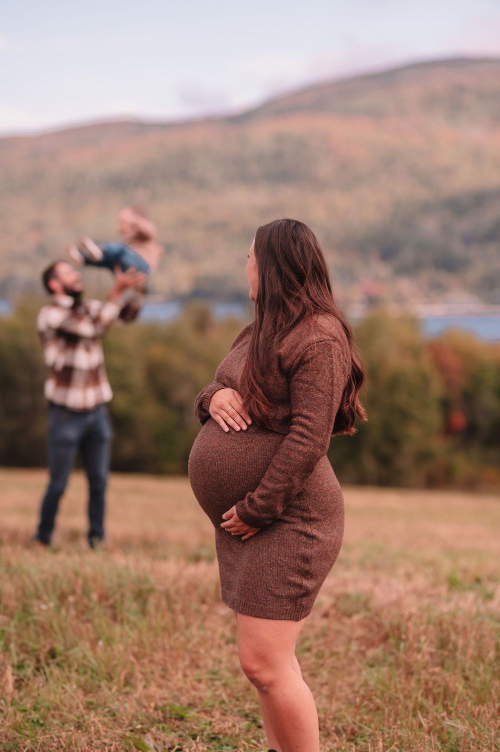 Maternity photoshoot in the mountains with fall foliage in the background.