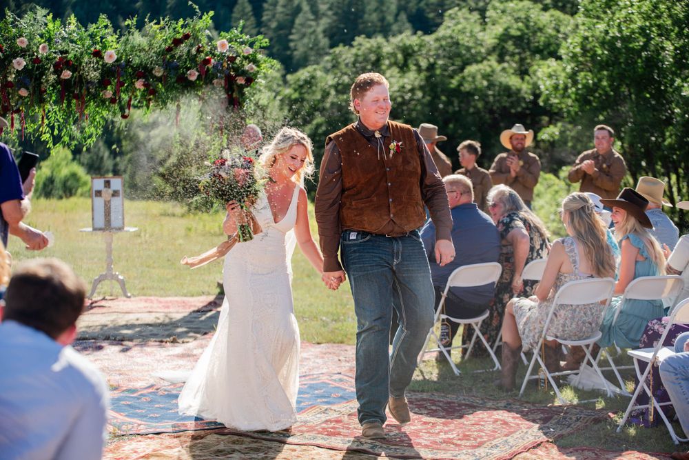 Wedding couple coming down the aisle photo. Colorado. Bride and groom. married.