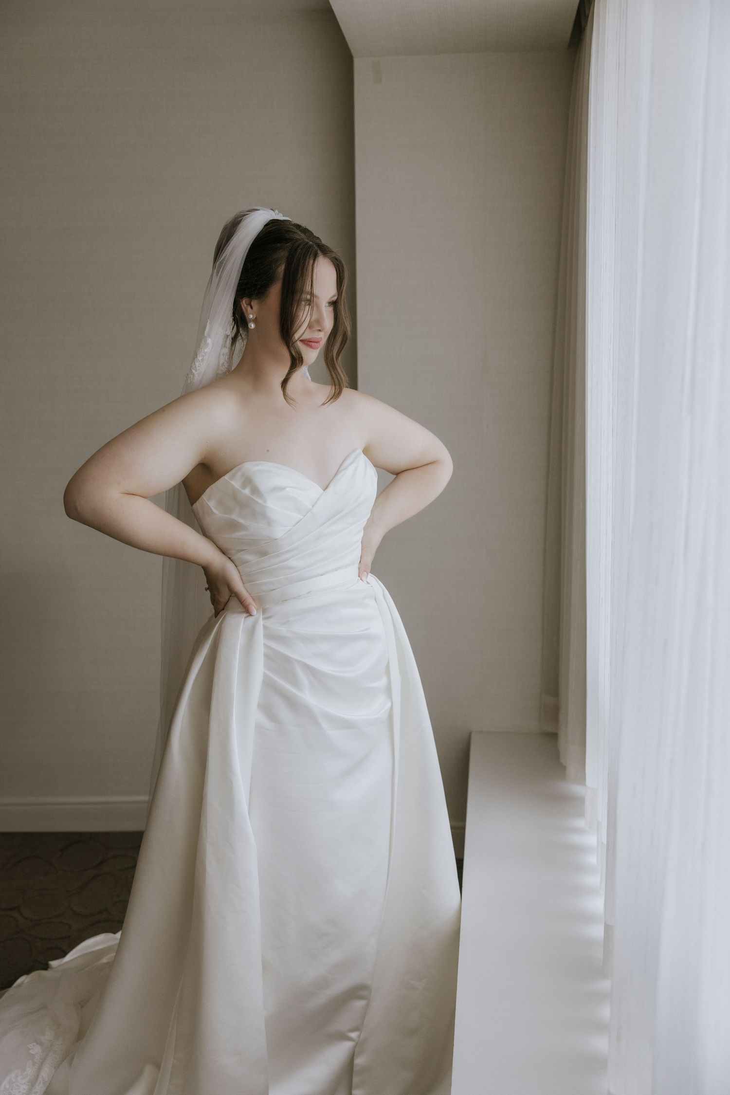 Ethereal bridal portraits through sheer veil fabric create a romantic and dreamy effect.