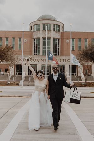 Newlyweds exit the Fort Bend County Justice Center building after their ceremony.