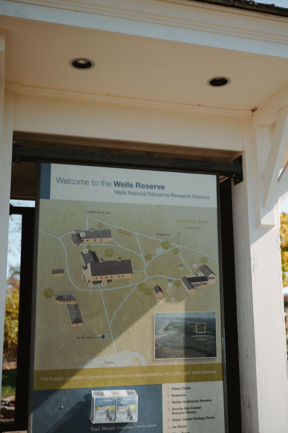 A visitor information map display shows the layout of the Wells Reserve at a nature preserve entrance.