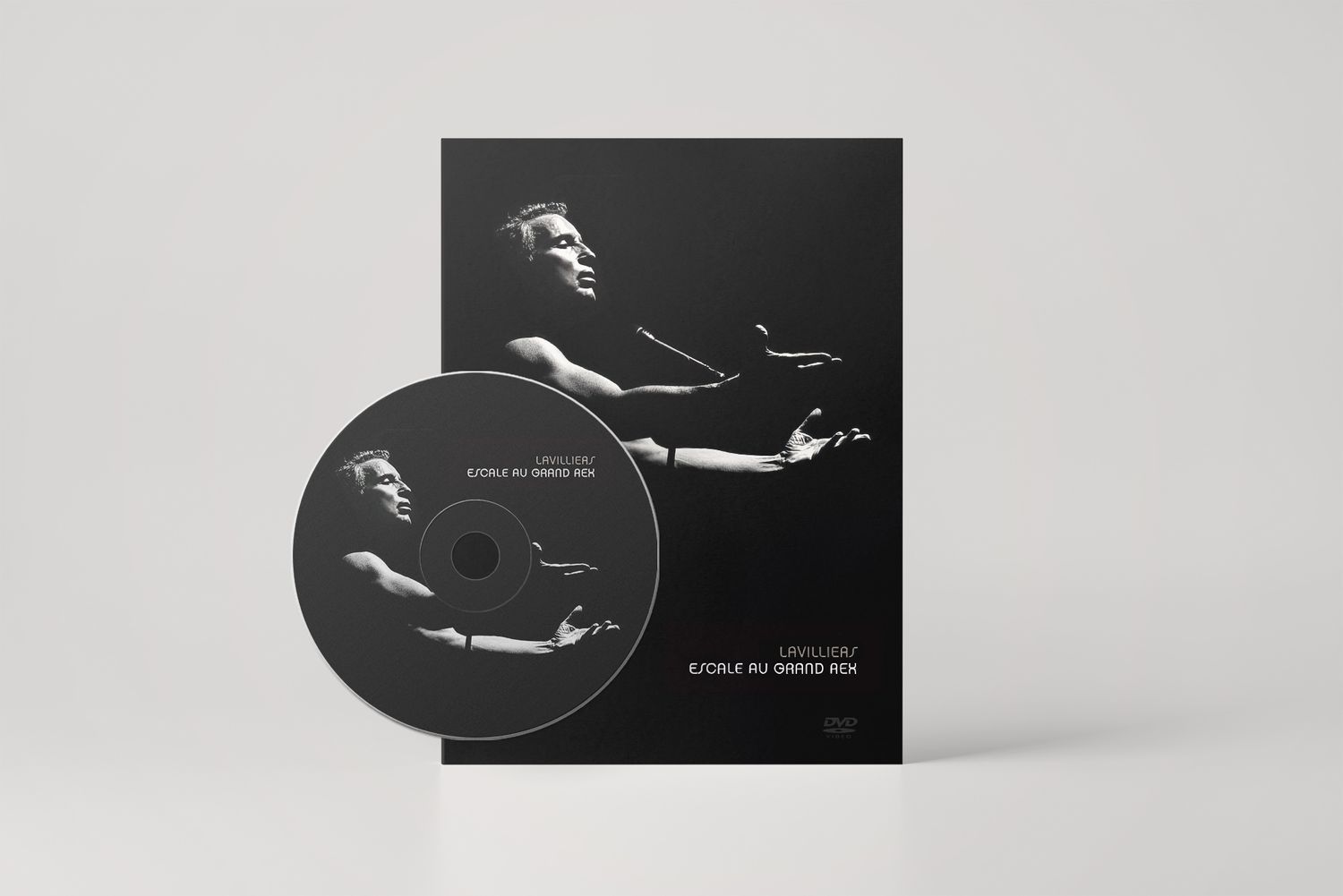 Minimalist black and white album artwork with CD and sleeve on light gray background.