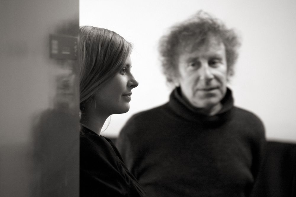 Artistic black and white portrait of two people in conversation.
