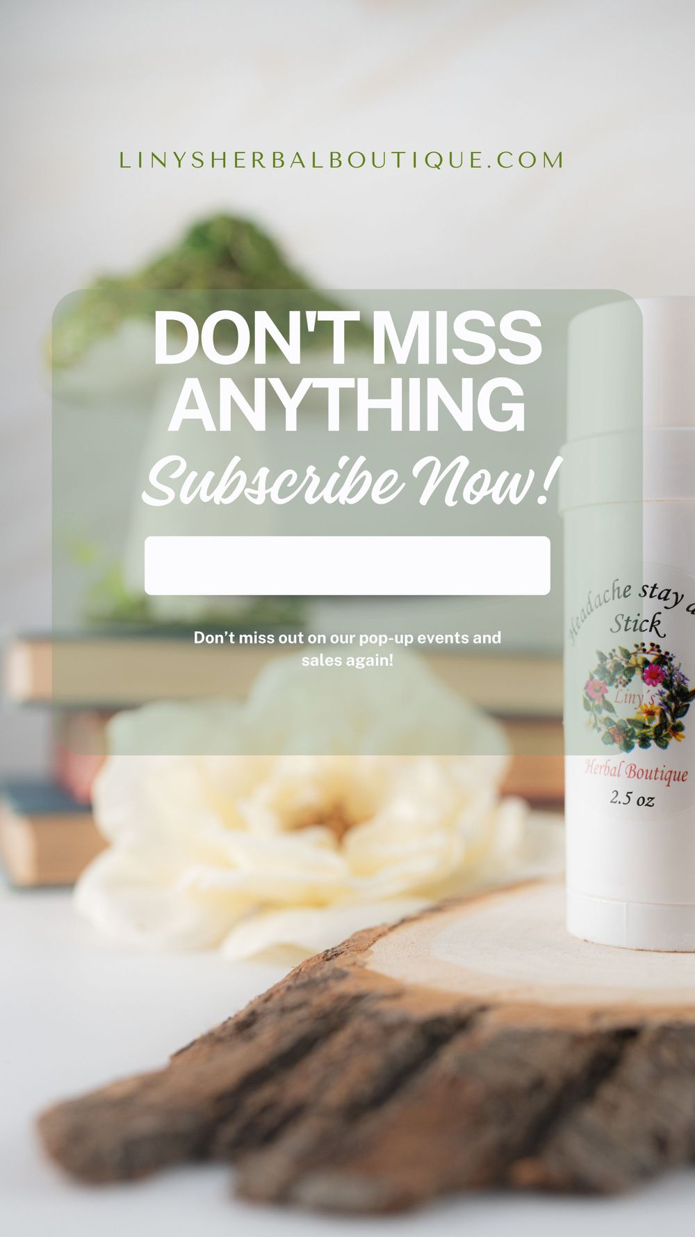 Newsletter signup page for Liny's Herbal Boutique with product display on wooden surface.
