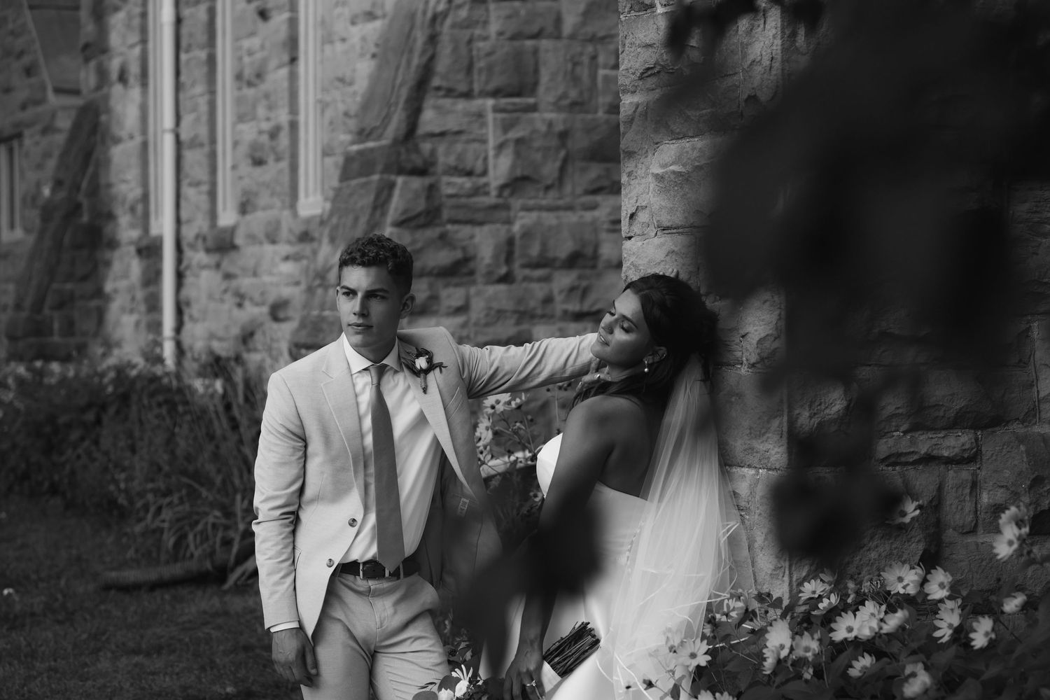 An intimate wedding moment showing pure joy and laughter in natural sunlight.