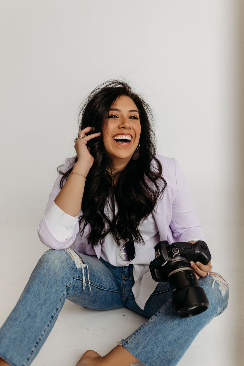 Cassandra with Photographs by Cass poses for a headshot with her Canon camera. She is a Tahlequah Wedding Photographer serving Oklahoma.