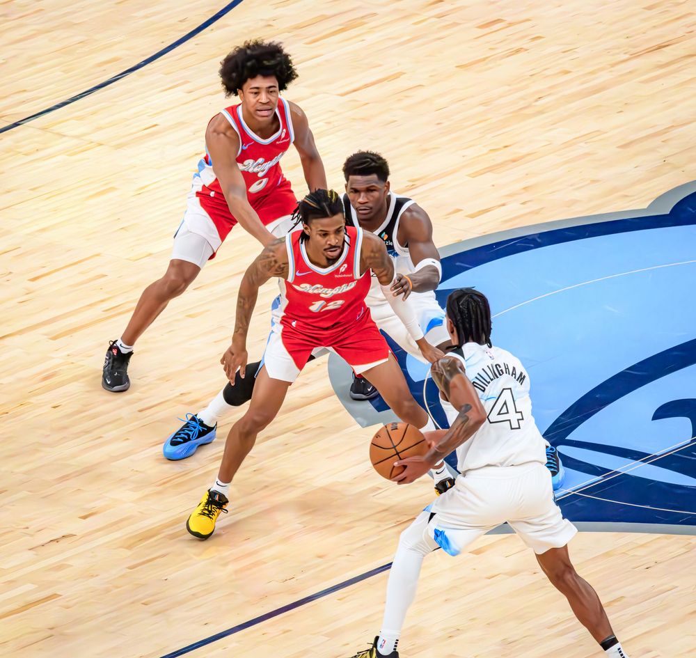NBA basketball players compete for possession of the ball during an intense game on the court.