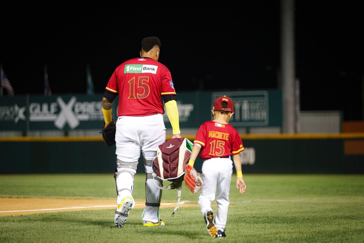 Martín “Machete” Maldonado is accompanied by his son during the pregame routine in his final season while playing in Puerto Rico.
