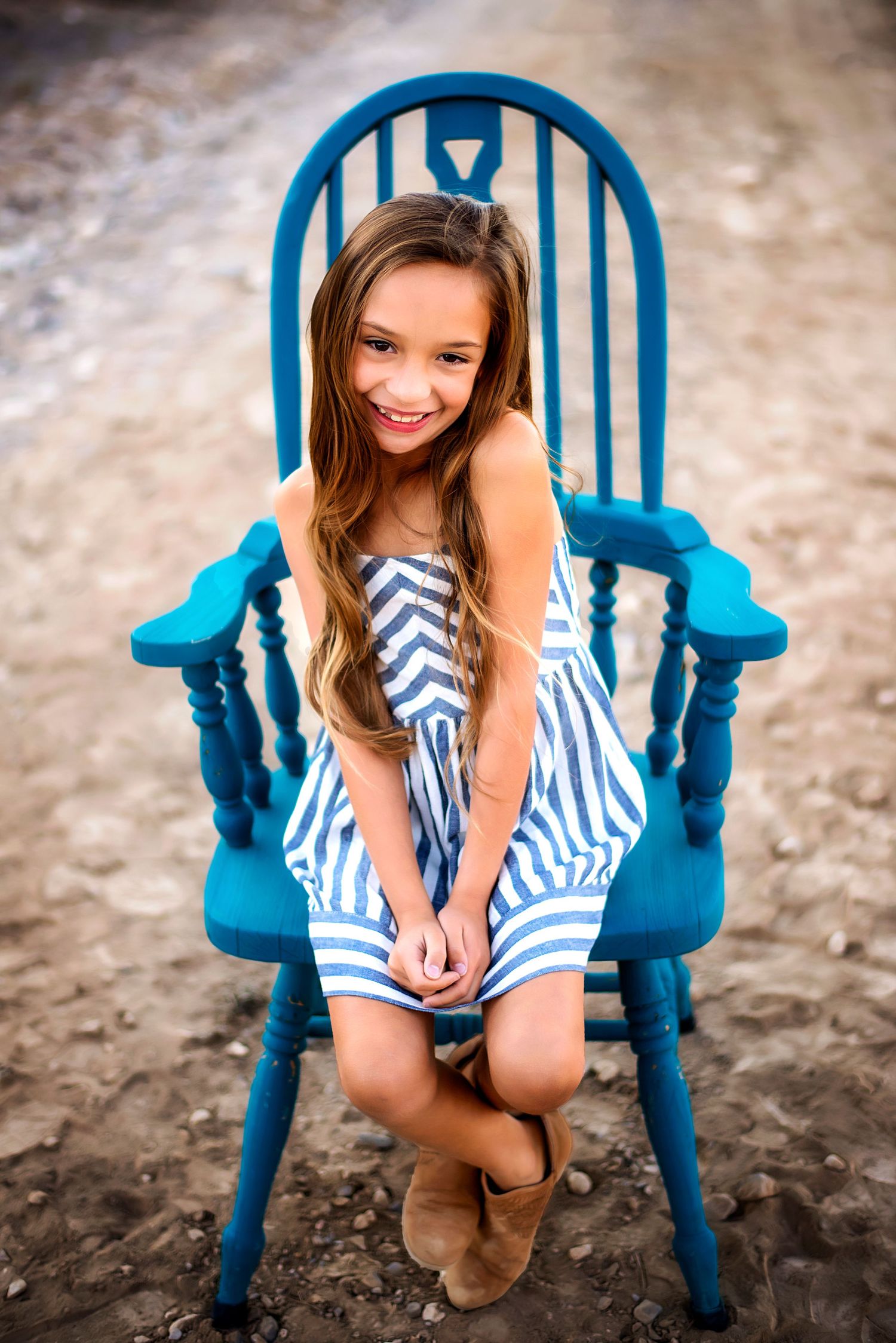 Girl sitting on blue chair during family photography session Wenatchee, WA