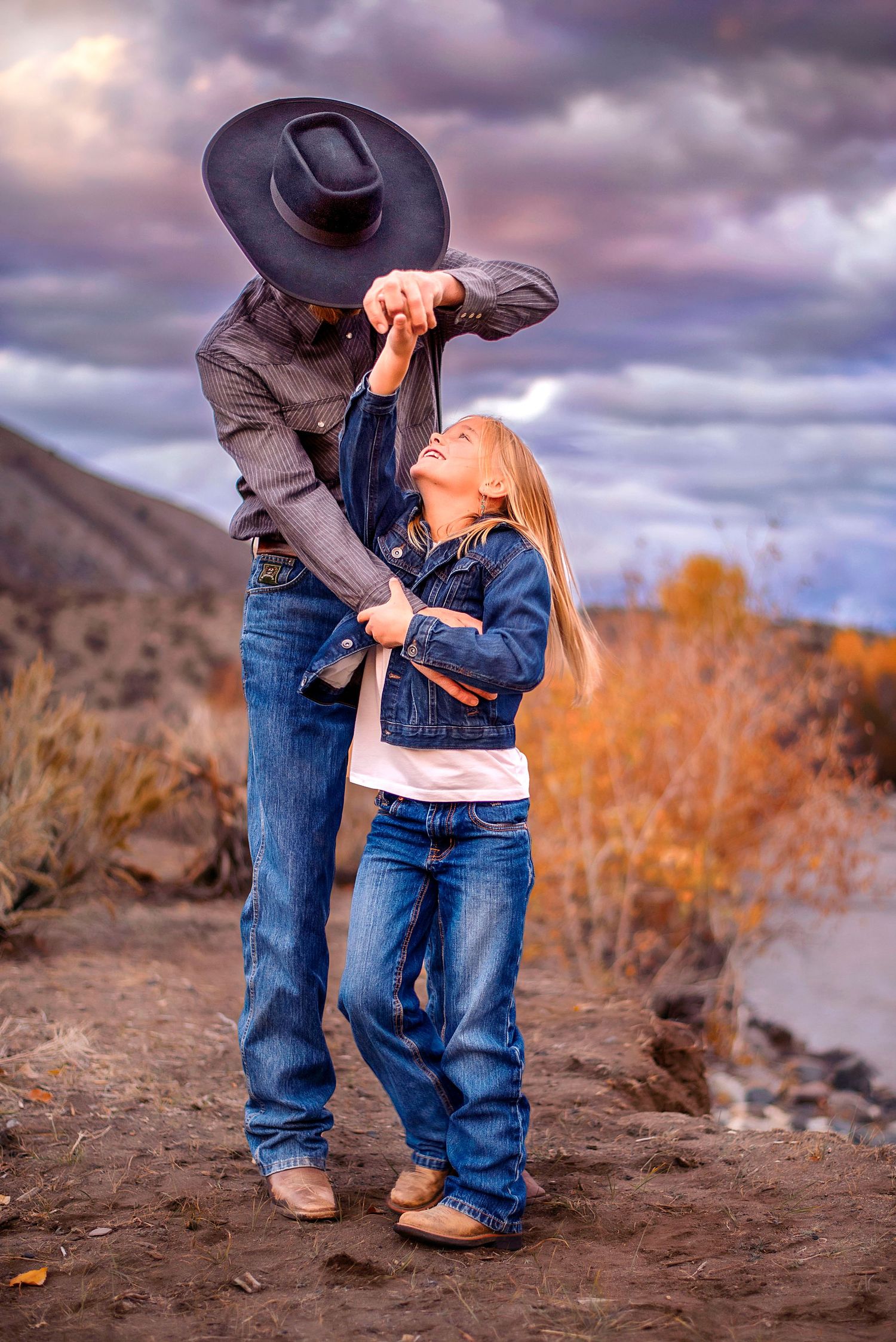 Dad and daughter dance by the river in Ellensburg, Washington for family photography photo shoot.