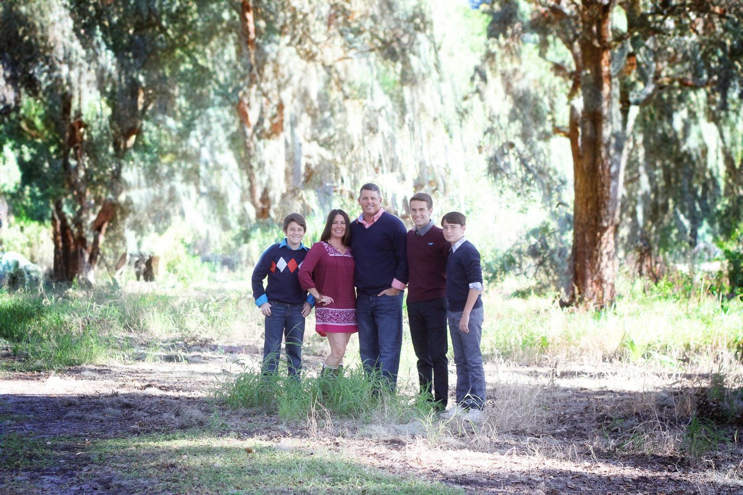 Group walking together on tree-lined path during outdoor photo session.