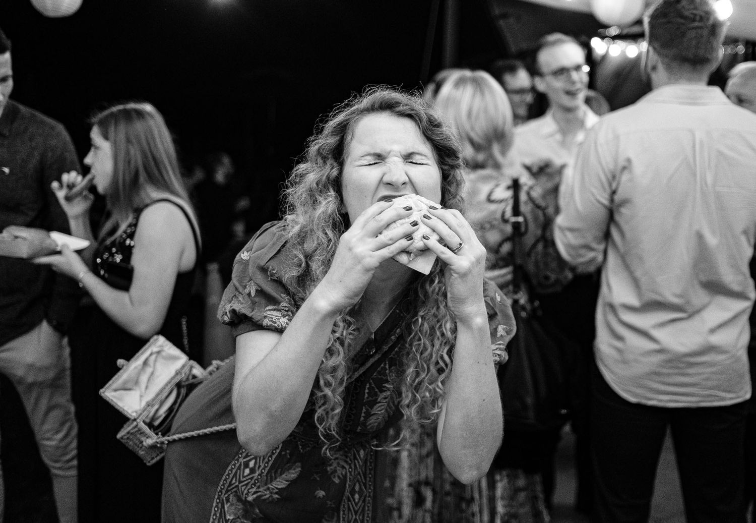 Wedding reception guests enjoying refreshments and conversation in a casual atmosphere.