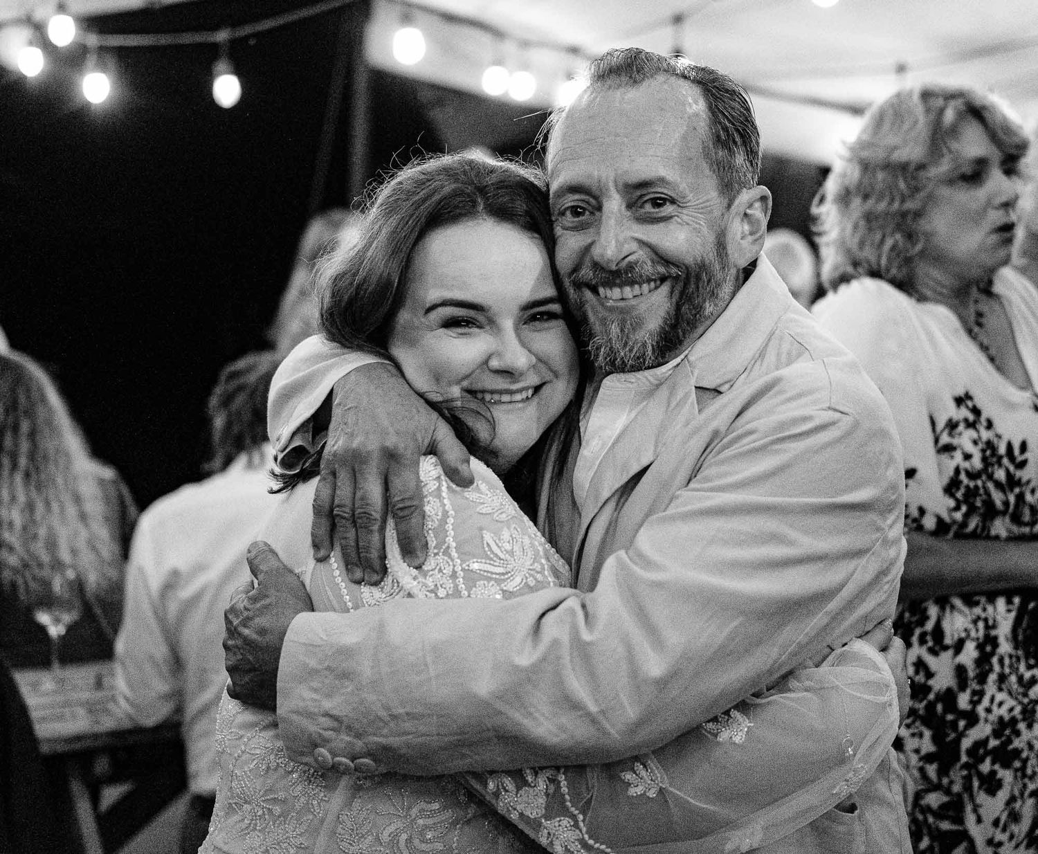 Joyful moments captured during wedding party celebrations in black and white photography.