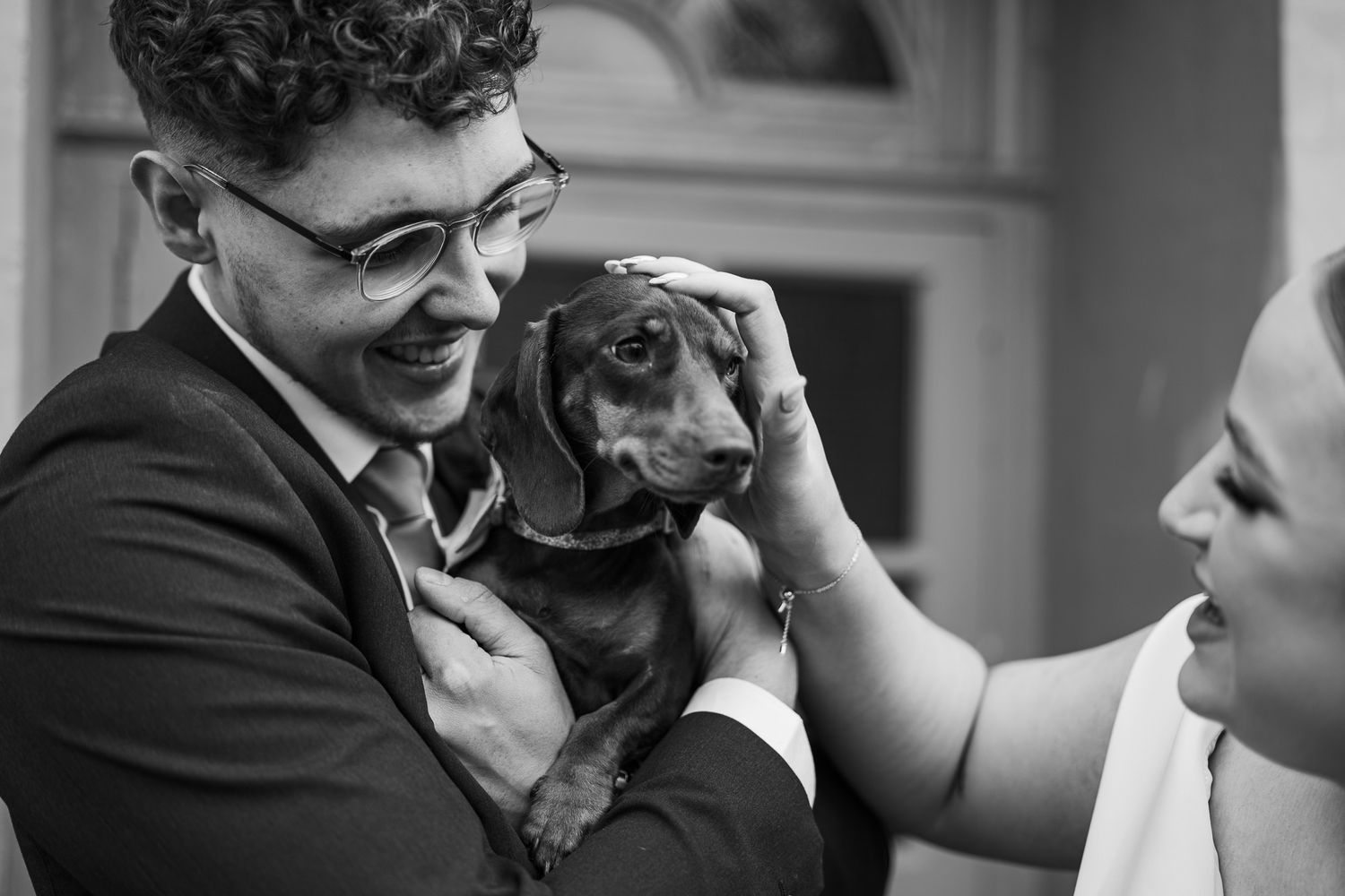 Black and white candid moment during a wedding celebration.