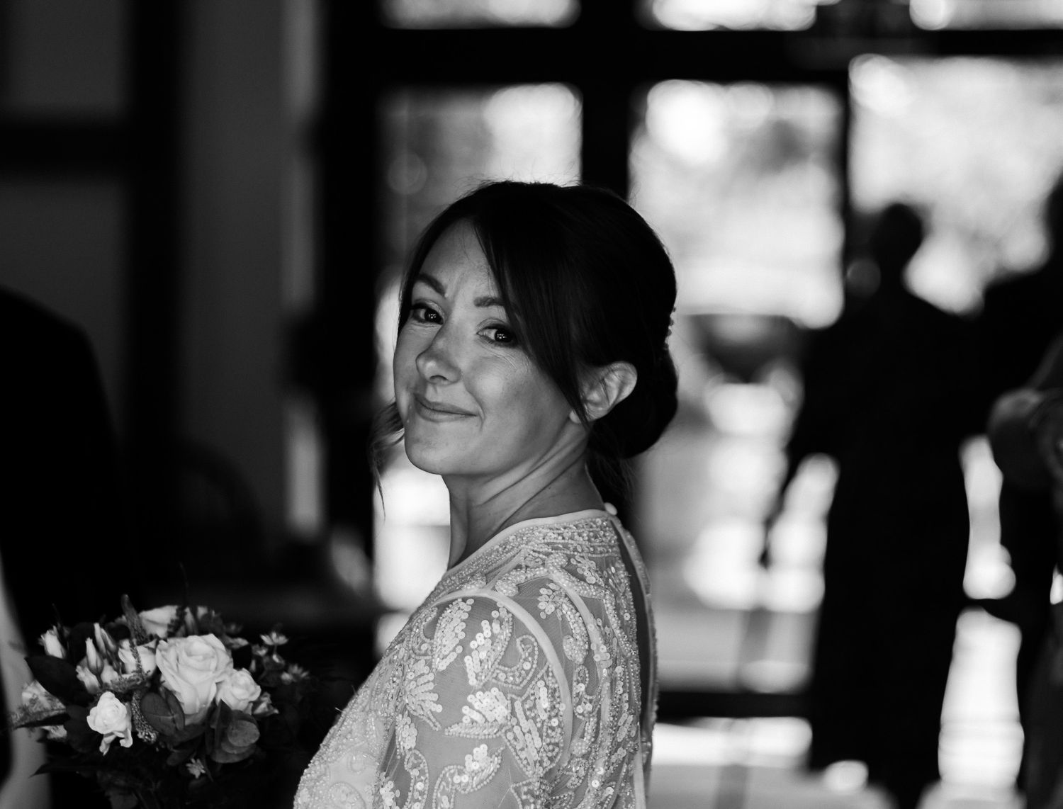 Elegant lace wedding dress detail captured in soft natural light.