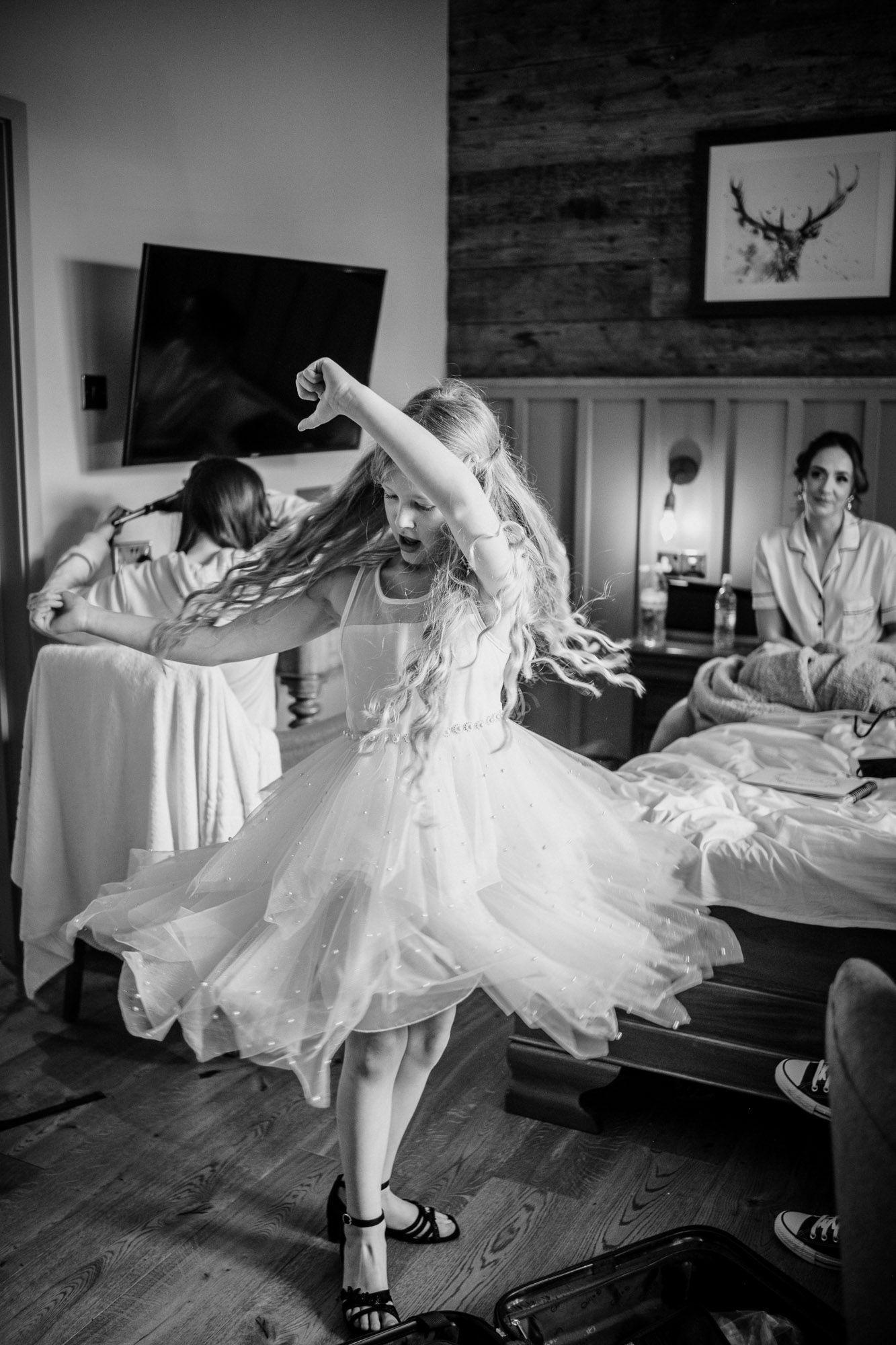 Black and white photos showing preparation moments with flowing white wedding dress.
