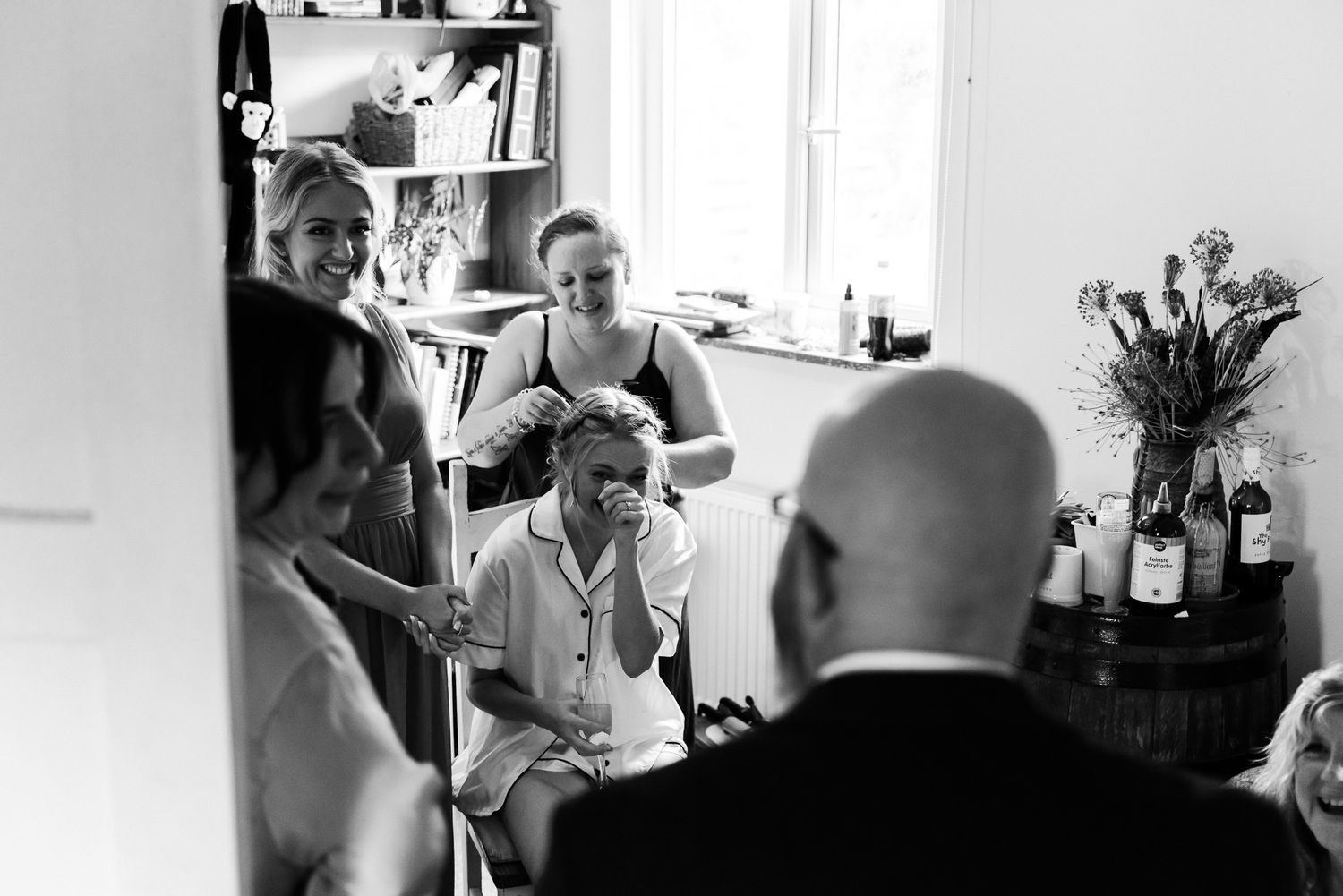 Wedding preparation moments captured in bright indoor setting with natural light.