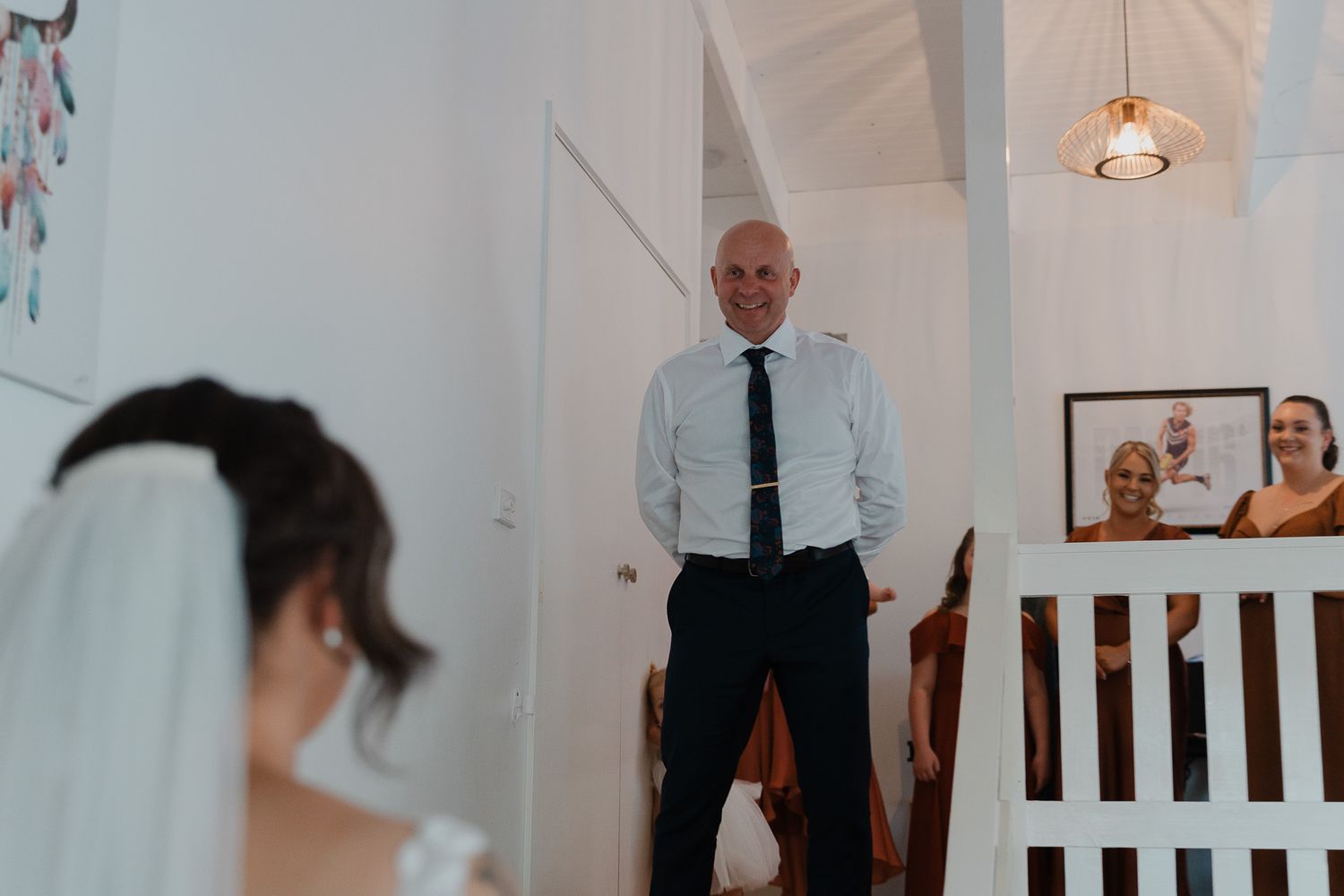 Wedding ceremony details with white decor and lighting.