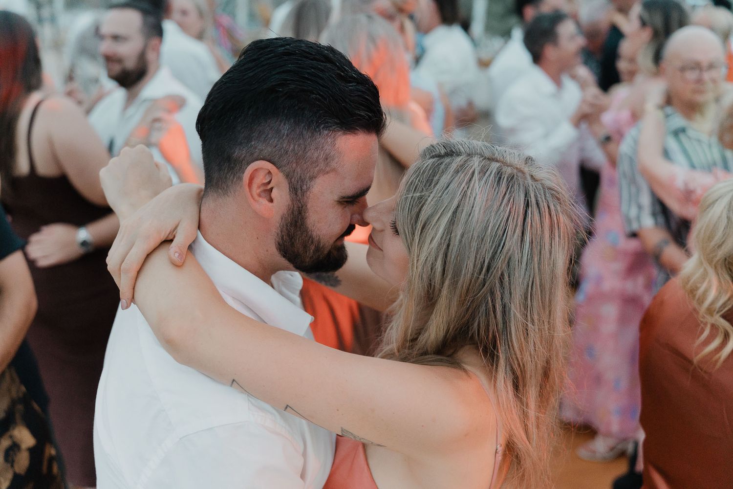 Wedding reception dance floor filled with celebrating guests.
