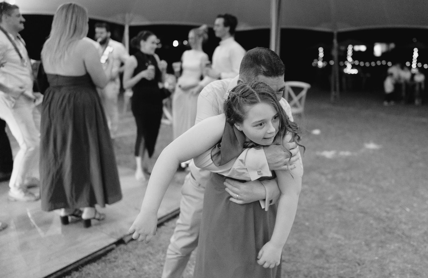 Couples dancing together at a formal event in black and white.
