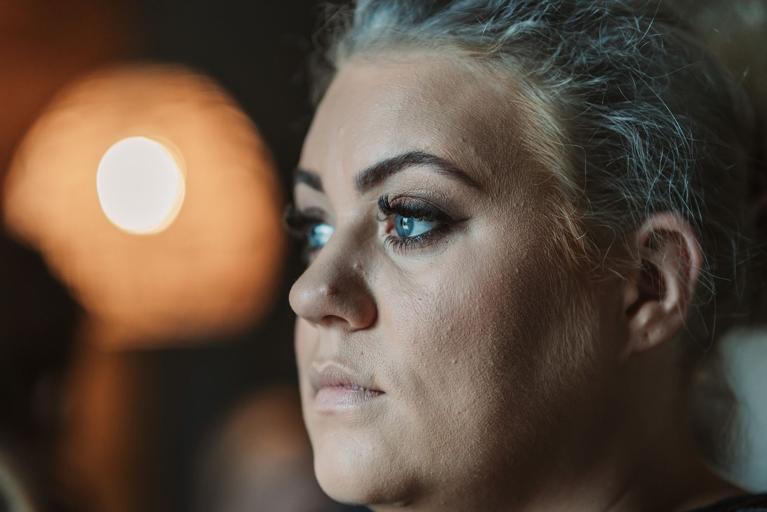 Close-up artistic portrait with dramatic lighting and soft focus effects.