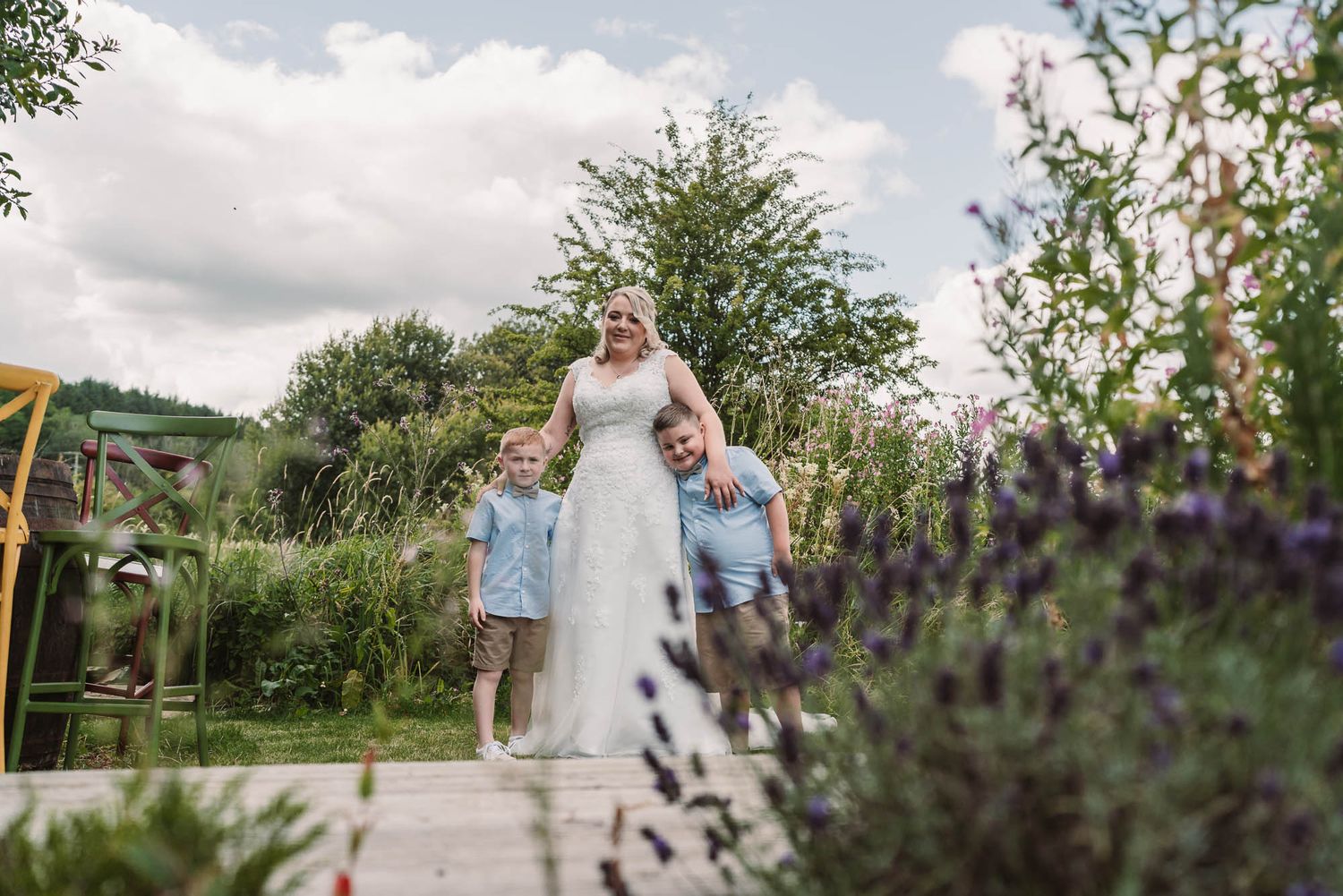 Beautiful outdoor garden scene with blooming flowers and cloudy sky.
