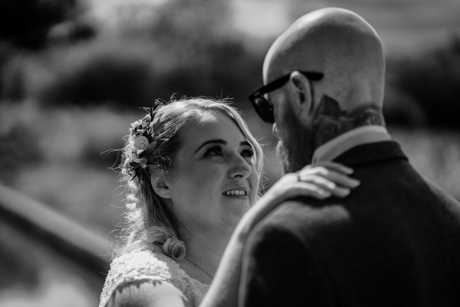 Black and white candid moment captured during an outdoor celebration.