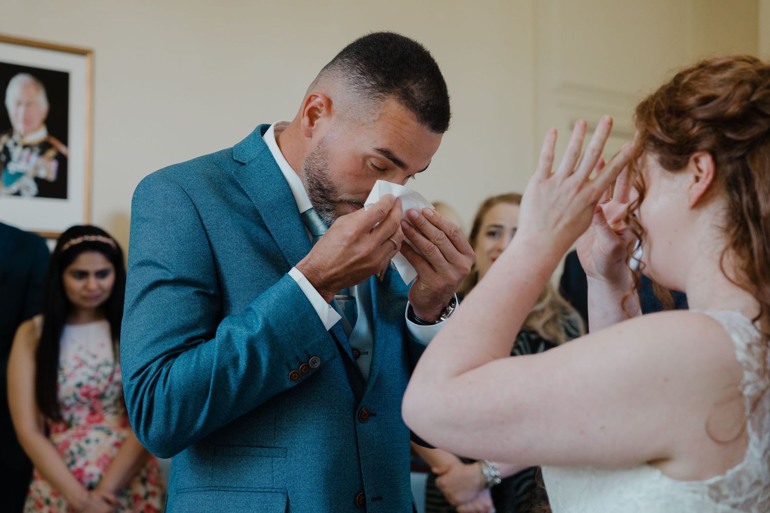Emotional wedding moments captured as couple reacts during ceremony.