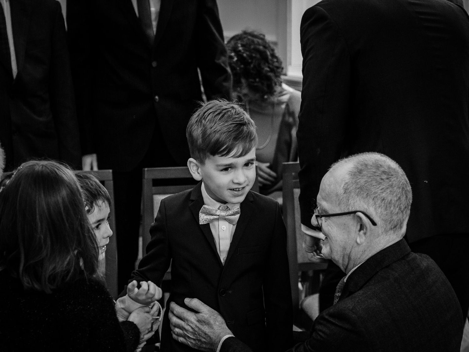 Black and white candid shots of wedding guests during a reception.
