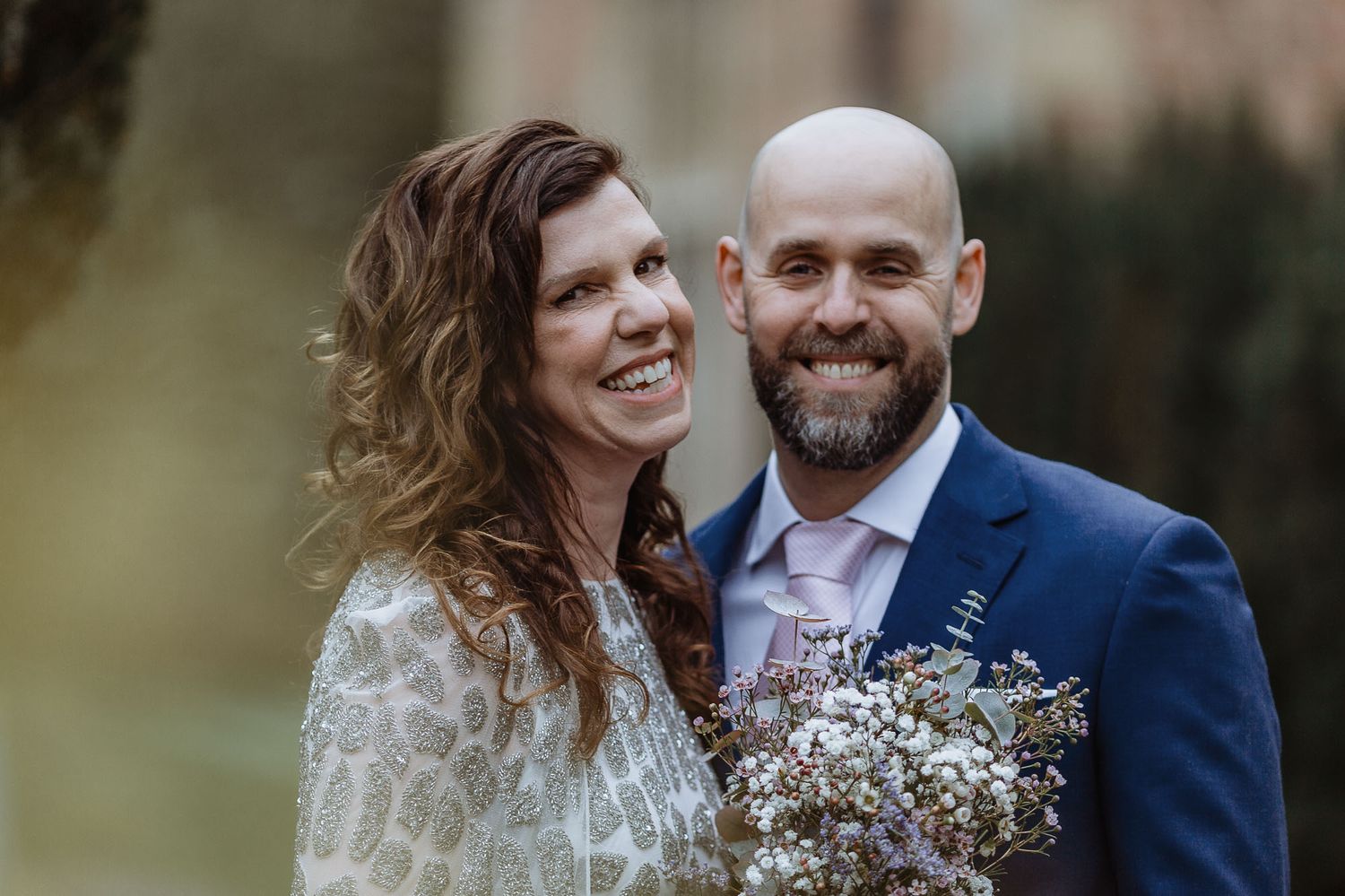 Romantic outdoor wedding portraits with natural lighting and floral bouquet.