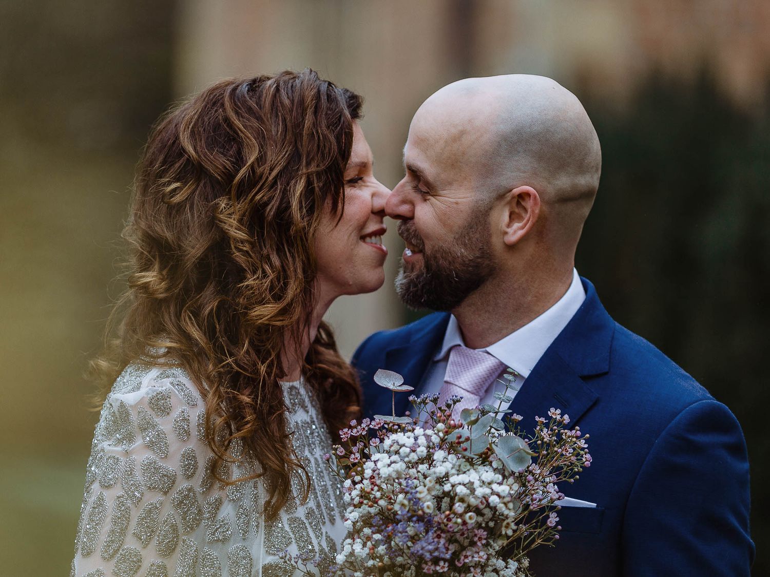 Intimate wedding couple portraits against a natural outdoor backdrop.