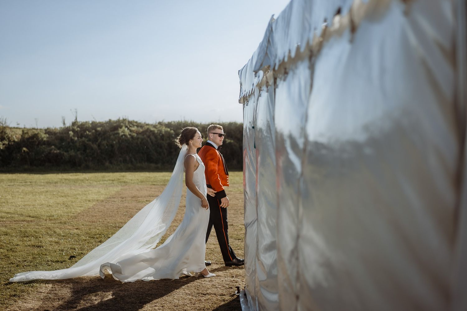 Flowing white fabric creates ethereal effect in outdoor field setting.