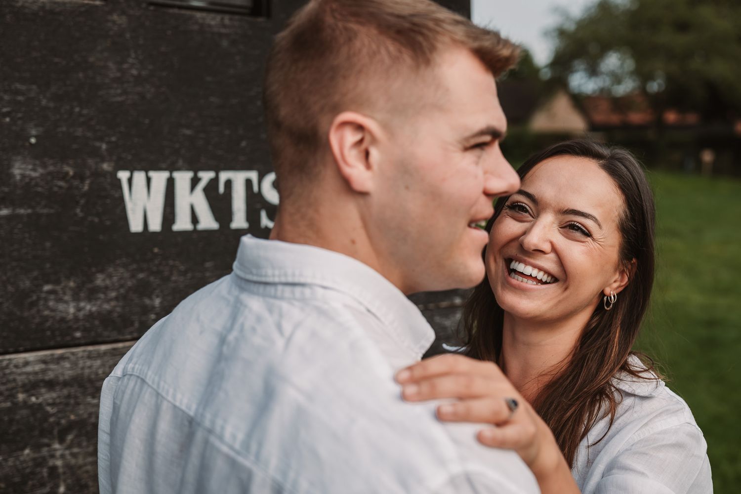 Intimate outdoor couple photography session with natural expressions and laughter.